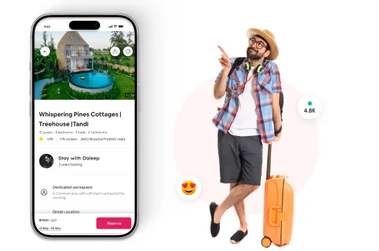 Vacation rental app on a phone next to a traveler with luggage